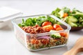 airtight glass container with layered quinoa salad for office lunch