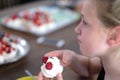 Airy meringue cake with berries in the hands of a girl