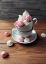 The airy meringue white and pink lies on a light Desk in rows and columns.