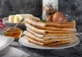 Airy sweet pancakes on a plate. A mountain of pancakes on the table.