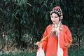 Aisa Chinese woman Peking Beijing Opera Costumes dress garden China traditional drama perform ancient Bamboo flute instruments Royalty Free Stock Photo