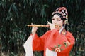 Aisa Chinese woman Peking Beijing Opera Costumes dress garden China traditional drama perform ancient Bamboo flute instruments Royalty Free Stock Photo