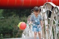 Aisa cute naughty lovely child girl play with balloon have fun outdoor in summer park happy smile happiness funny childhood Royalty Free Stock Photo