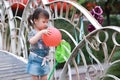 Aisa cute naughty lovely child girl play with balloon have fun outdoor in summer park happy smile happiness funny childhood Royalty Free Stock Photo