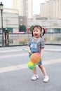 Aisa cute naughty lovely child girl play with balloon have fun outdoor in summer park happy smile happiness funny childhood Royalty Free Stock Photo