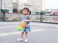 Aisa cute naughty lovely child girl play with balloon have fun outdoor in summer park happy smile happiness funny childhood Royalty Free Stock Photo