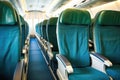 an aisle of airplane seats with fasten seatbelt signs on