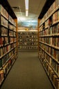 Aisle of books on bookshelves in public library