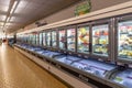 Aisle with refrigerated counters with frozen food in italian discount