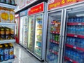 Aisle with various kinds of drinks on the Freezer shelves inside Alfamart