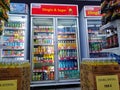 Aisle with various kinds of drinks on the Freezer shelves inside Minimarket