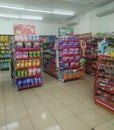 Aisle with various kinds of goods on the shelves inside Alfamart