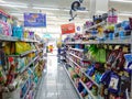 Aisle with various kinds of goods on the shelves inside minimarket