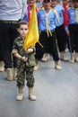 Hezbollah`s child supporter Carries the flag of Hezbollah Royalty Free Stock Photo