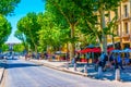 AIX-EN-PROVENCE, FRANCE, JUNE 18, 2017: People are strolling on cours Mirabeau in the center of Aix-en-Provence, France Royalty Free Stock Photo