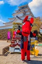 Japanese dresses a `Akabeko` mascot at Aizu-Wakamatsu Castle