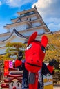 Aizuwakamatsu , Japan - April 21 2018: Unidentified Japanese dresses a `Akabeko` mascot at Aizuwakamatsu Castle