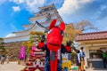 Japanese dresses a `Akabeko` mascot at Aizu-Wakamatsu Castle