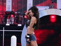 AJ Lee stands on turnbuckle holding hair as she celebrates win a Royalty Free Stock Photo