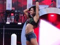 AJ Lee stands on turnbuckle holding hair as she smiles and celeb Royalty Free Stock Photo