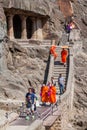 AJANTA, INDIA - FEBRUARY 6, 2017: Visitors of Buddhist caves carved into a cliff in Ajanta, Maharasthra state, Ind