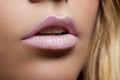 Ajar female mouth closeup. Delicate pink lips. Perfect skin.