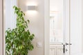 Ajar white door in the bright bathroom. Series switch and modern
