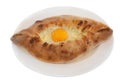 Ajarian khachapuri on dish isolated on white