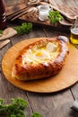 Ajarian khachapuri on a wooden board