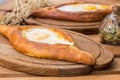 Ajarian khachapuri on wooden table. Traditional Georgian cuisine. cuisine of the Georgian people Royalty Free Stock Photo