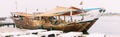 Ajman, UAE, United Arab Emirates - May 26, 2021: Dhow sailboat near pier in summer day. Sailboat moored near city pier