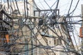 A mass of tangled utility wires above the streets of Delhi, India.