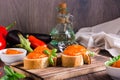 Ajvar delicious appetizer of pepper, eggplant and garlic on bread and in bowls on the table