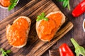 Ajvar delicious appetizer of pepper, eggplant and garlic on bread and in bowls. Top view. Closeup