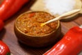 Ajvar from paprika, tomatoes, garlic and onions with spices on a brown wooden table. Balkan food. Selective focus Royalty Free Stock Photo