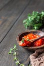 Ajvar pepper mousse or pindjur red vegetable spread made from paprika and tomatoes in wooden bowl on the rustic wooden table. Royalty Free Stock Photo