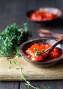 Ajvar pepper mousse or pindjur red vegetable spread made from paprika and tomatoes in wooden bowl on the rustic wooden table. Royalty Free Stock Photo