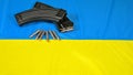 Ak-47 rifle magazines and ammunition lying on a Ukrainian flag