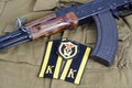 AK47 with Soviet Army Cadet shoulder mark and Soviet Army Transportation Corps shoulder patch on khaki uniform Royalty Free Stock Photo