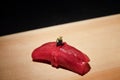 Akami sushi topped with caviar and gold flake, marinated