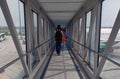 Passengers walk down the aisle to get to the plane