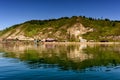 Ake Baikal close to village Port Baikal, Russia. Horizontal day view of the high shore, green forest, houses, clear lake