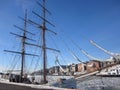 Aker Brygge in Oslo with a sailing ship lying in the Oslofjord  with ice floes, Norway Royalty Free Stock Photo