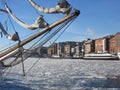 Aker Brygge in Oslo with a sailing ship lying in the Oslofjord  with ice floes, Norway Royalty Free Stock Photo