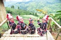 Akha hill tribe people sit and admire the view on Doi Mae Salong, Chiang Rai Province, Thailand.