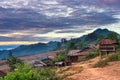 Akha village in the mountains of North Laos, sunset dramatic sky. Remote tribal village travel destination for tribal trekking,