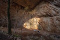 Akmeshit or Akmechet cave. Huge cavern with hole and green trees groving under