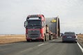 A truck is carrying an oversized load along the highway.