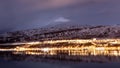 Akureyri, Iceland city lights during blue hours with a backdrop of ice mountains