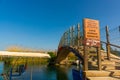 AKYAKA, MUGLA, TURKEY: Arched bridge and boats moored at the Azmak River in the village of Akyaka